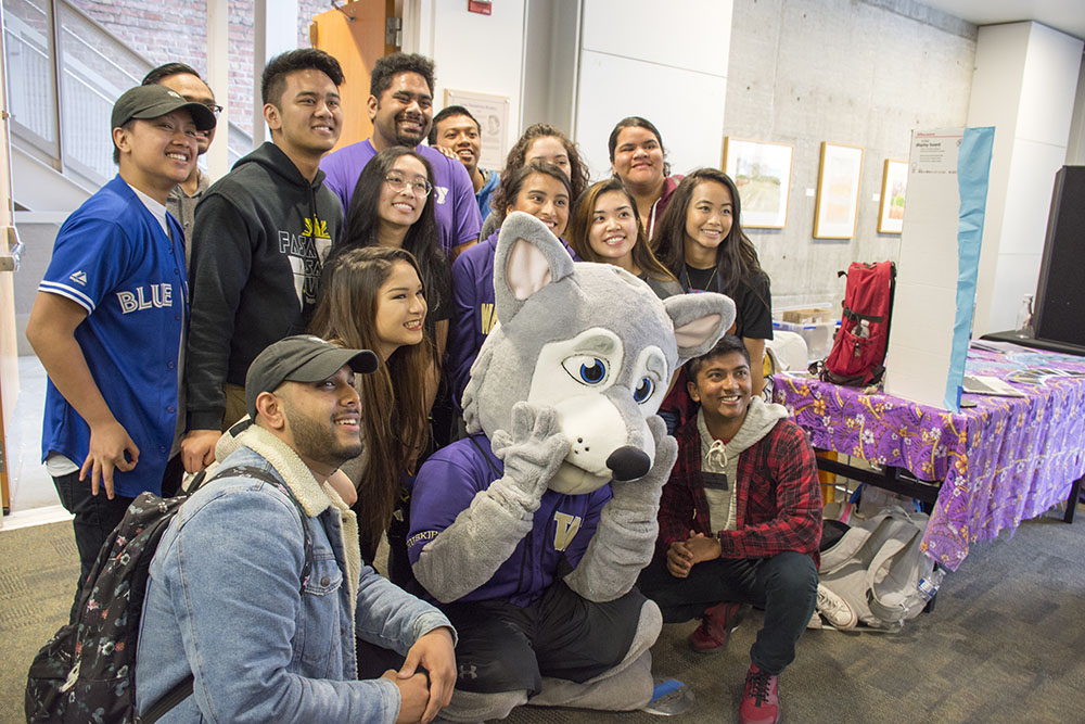 Photo of students surrounding Hendrix the Husky mascot