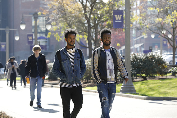 Photo of two students outdoors walking