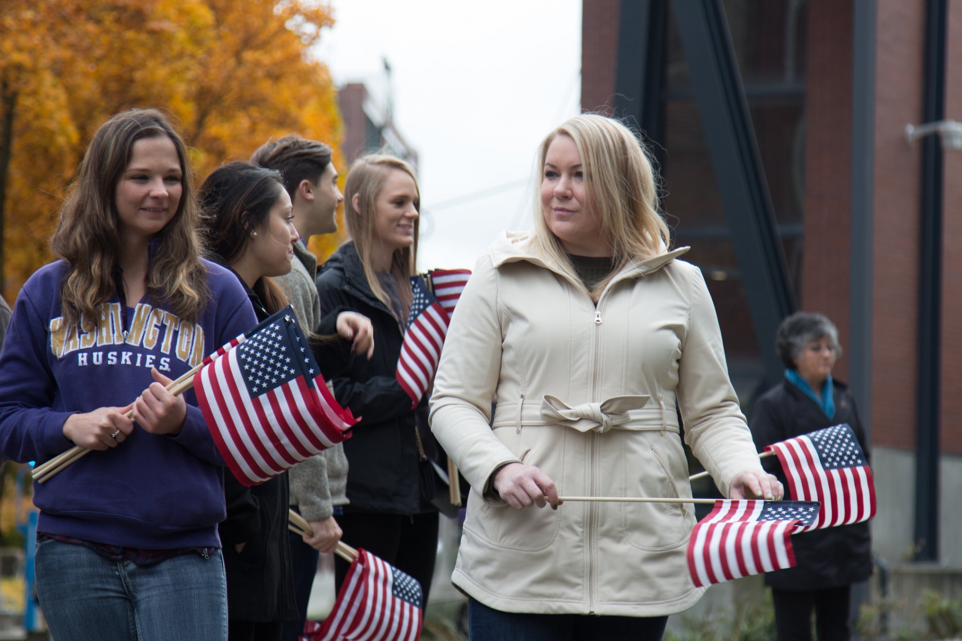 Photo of two women outside holding flags