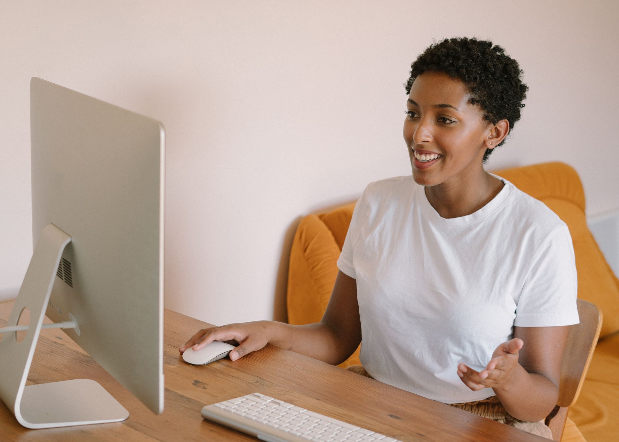 Photo of woman talking to a computer screen