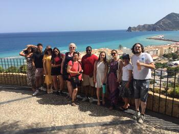 Group of Alicante students and program director by the sea