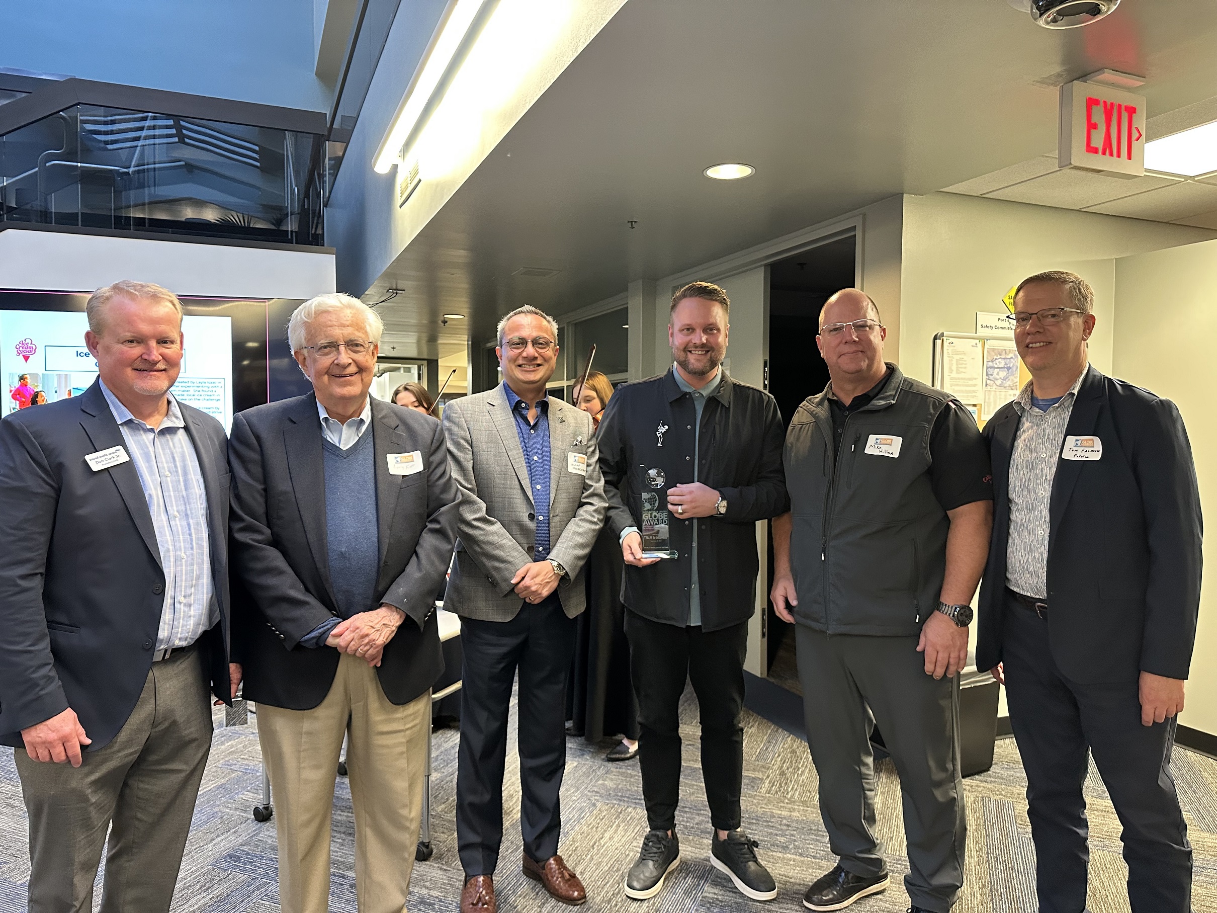 Group Photo of Don Clark Jr., Larry Kopp, Tom Falskow, Michael Hiller, MBA, Erin Galeno, and Milgard School Dean Merchant at the Globe Awards