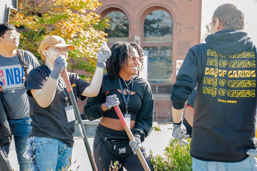 UW Tacoma students outside on campus do landscape maintenance during 2023 Day of Caring.