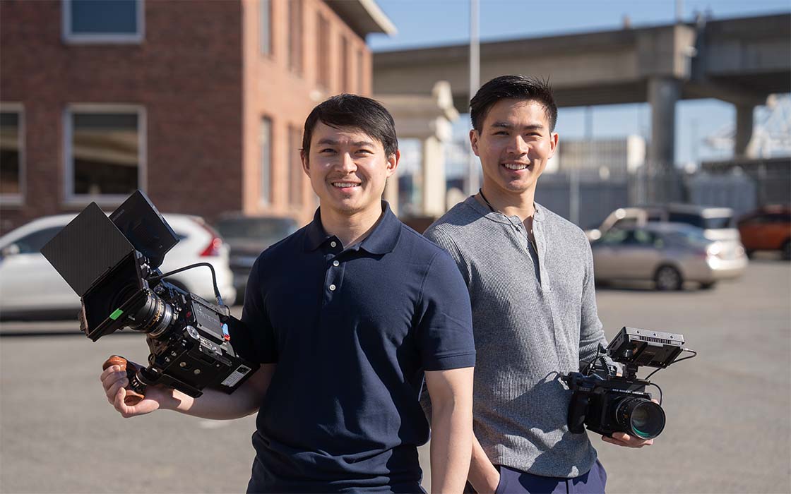 Nuk and Nut Suwanchote holding camera equipment