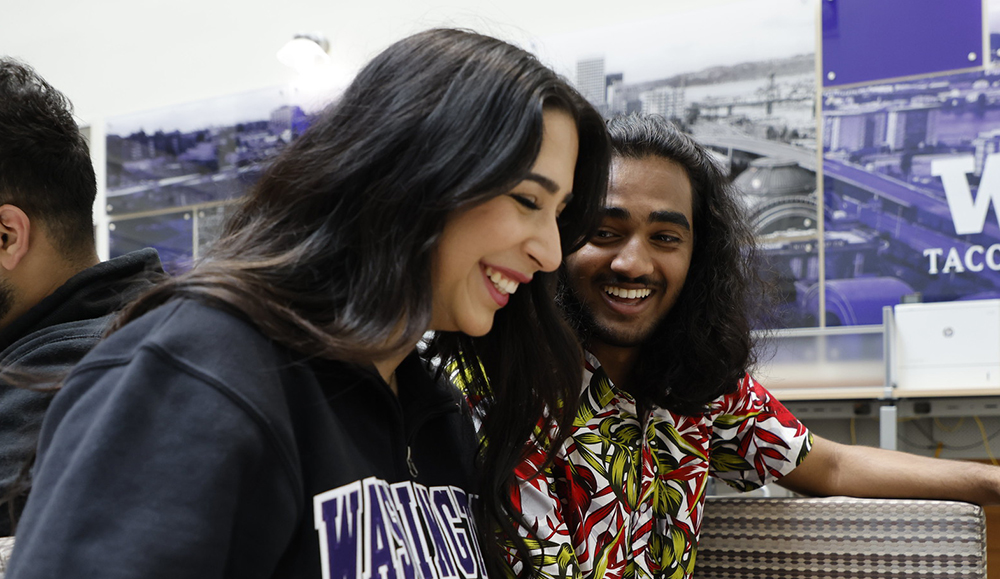 Photo of two students laughing and smiling