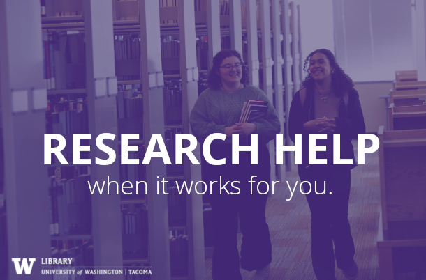 Research Help at UW Tacoma Library: Two students walk through the library together with books.