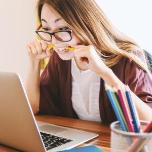 Lady biting pencil