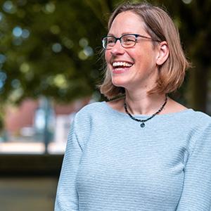 Headshot of UW Tacoma staff member Annemarie Martin. Martin is turned sideways and is looking off to the right. She is smiling. Martin has brown hear and wears glasses. She is wearing a light colored shirt.