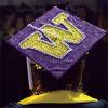 Photo of person wearing decorated graduation cap with the University logo