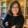 Dr. Heather Dillon in front of bookshelves