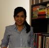 Person standing next to a bookcase