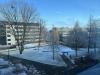 Image of town center in daylight with snow covering the ground and buildings