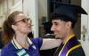 Staff member adjusting graduation cap on head of member of UW Tacoma Class of 2024