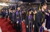 Students process along the "red carpet" in the Tacoma Dome at the start of the 2024 UW Tacoma Commencement.