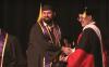 A student shakes the hand of Executive Vice Chancellor for Academic Affairs Andrew Harris as he receives his degree at the 2024 UW Tacoma Commencement.