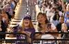 Two audience members standing at a railing in the Tacoma Dome during the 2024 UW Tacoma Commencement.